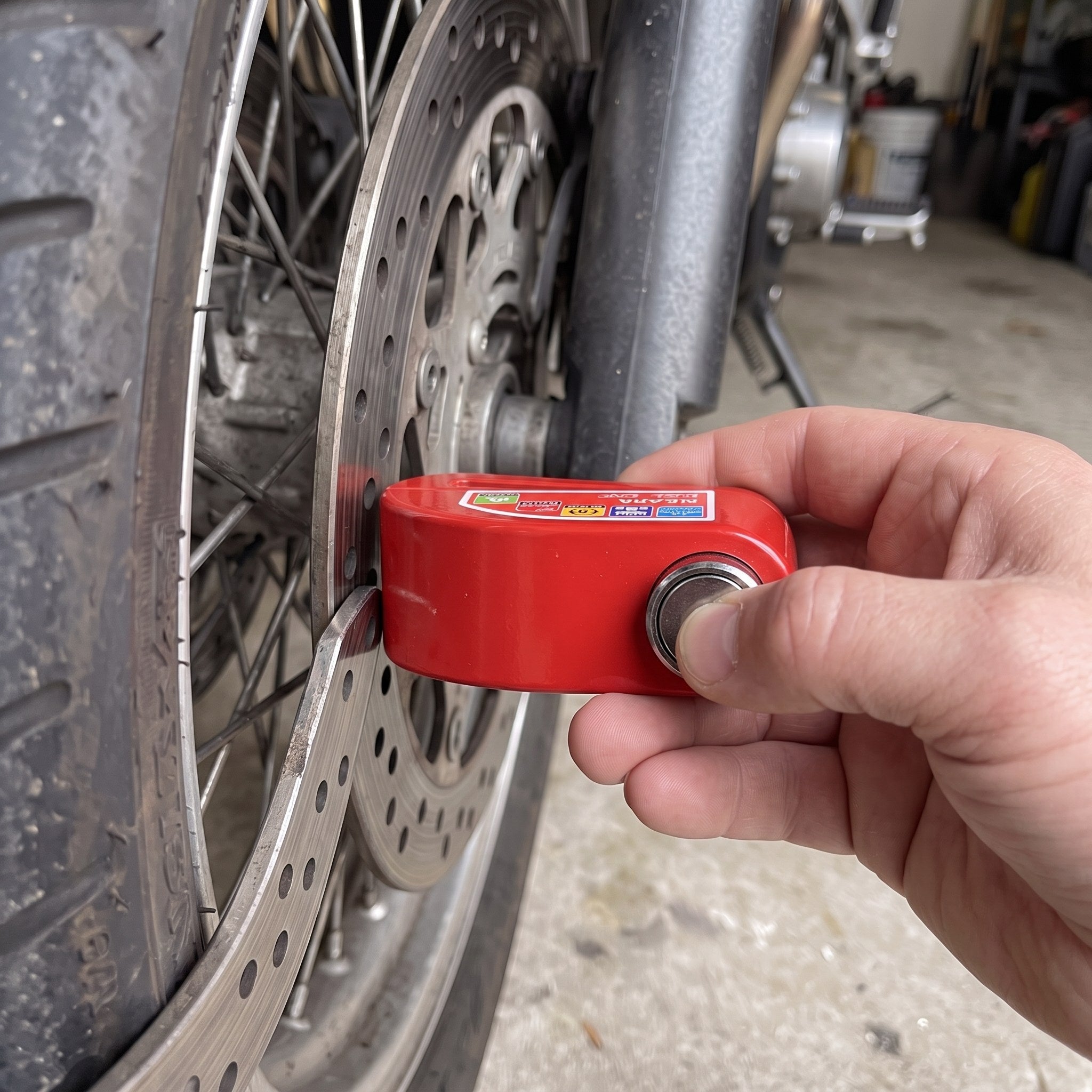 RideLatch alongside a compatible drilled motorcycle brake disc
